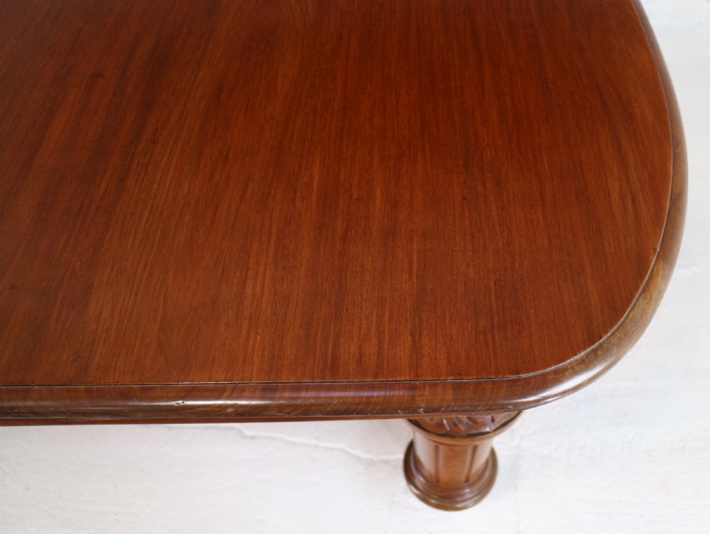 A large Victorian mahogany extending dining table featuring six turned carved legs fitted with brass castors and four removable leaf inserts. View XIX