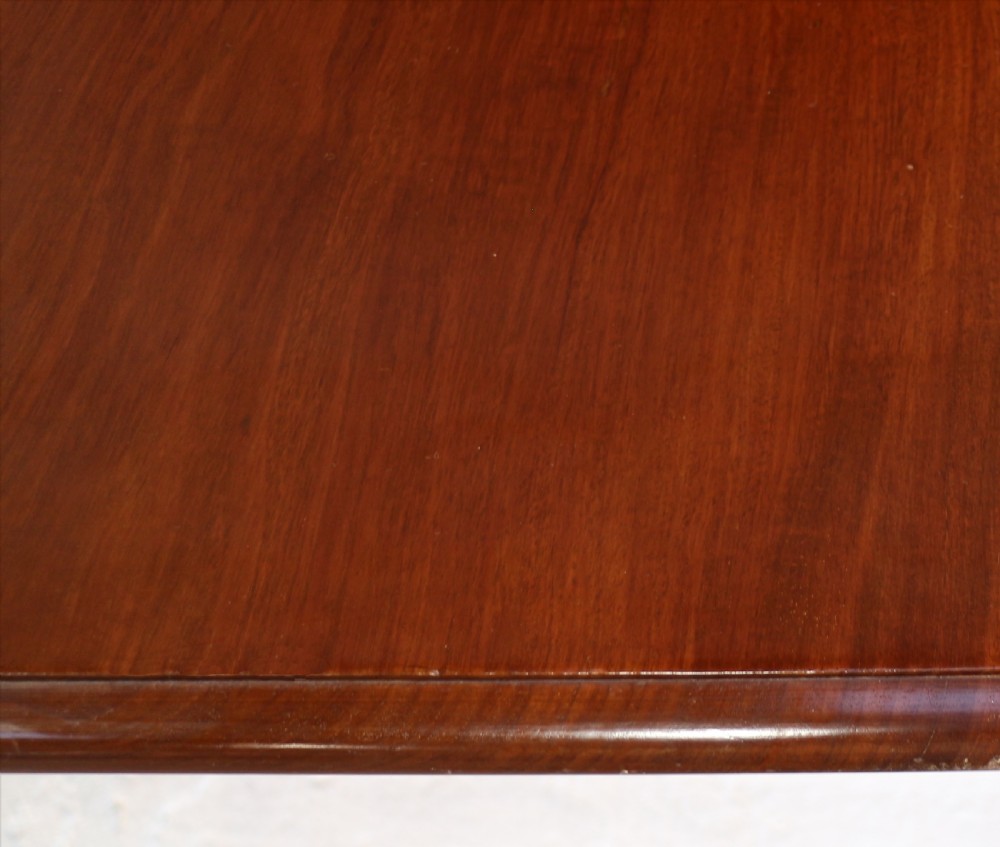 A large Victorian mahogany extending dining table featuring six turned carved legs fitted with brass castors and four removable leaf inserts. View XX