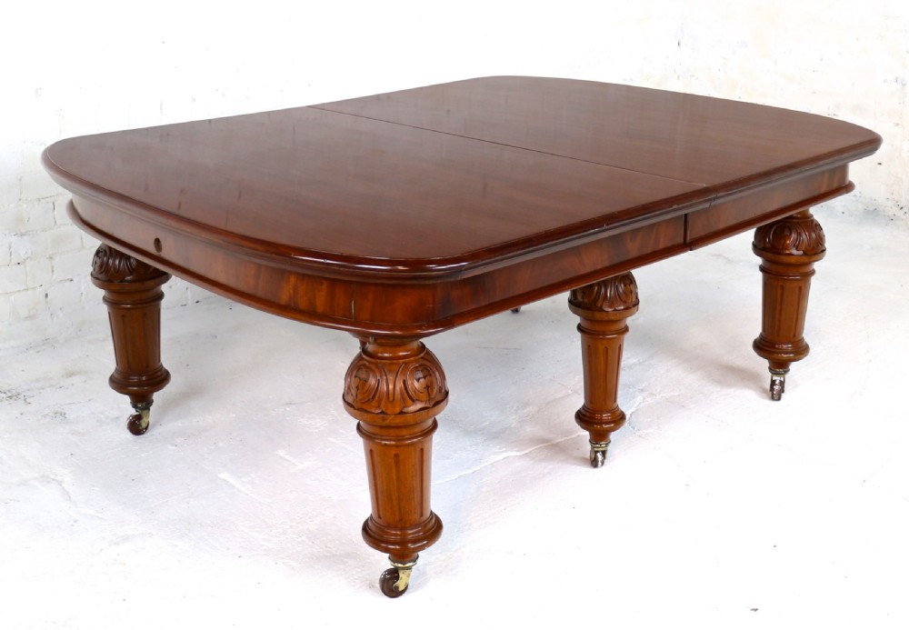 A large Victorian mahogany extending dining table featuring six turned carved legs fitted with brass castors and four removable leaf inserts. View XXI