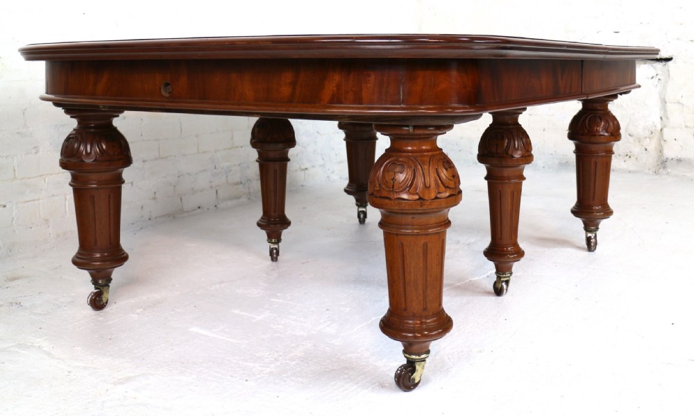 A large Victorian mahogany extending dining table featuring six turned carved legs fitted with brass castors and four removable leaf inserts. View XXVIII