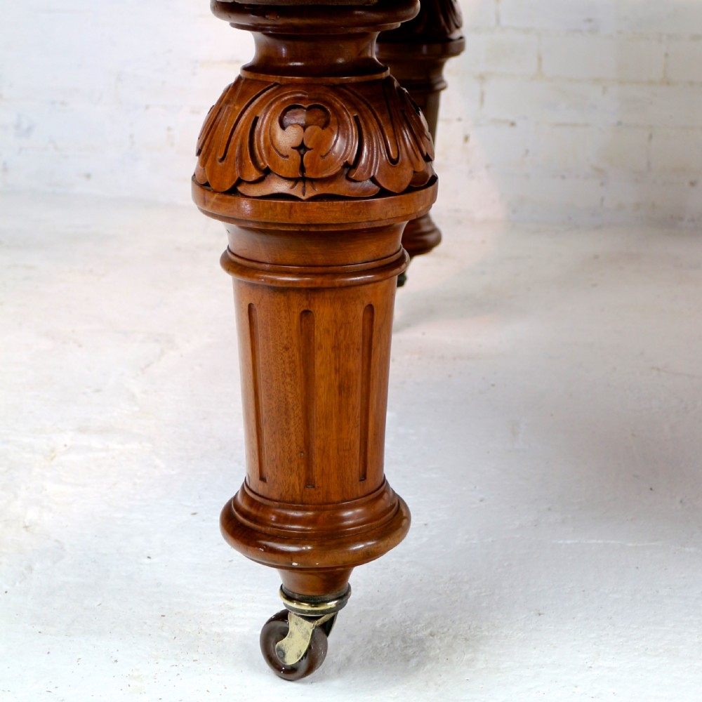 A large Victorian mahogany extending dining table featuring six turned carved legs fitted with brass castors and four removable leaf inserts. View XXX