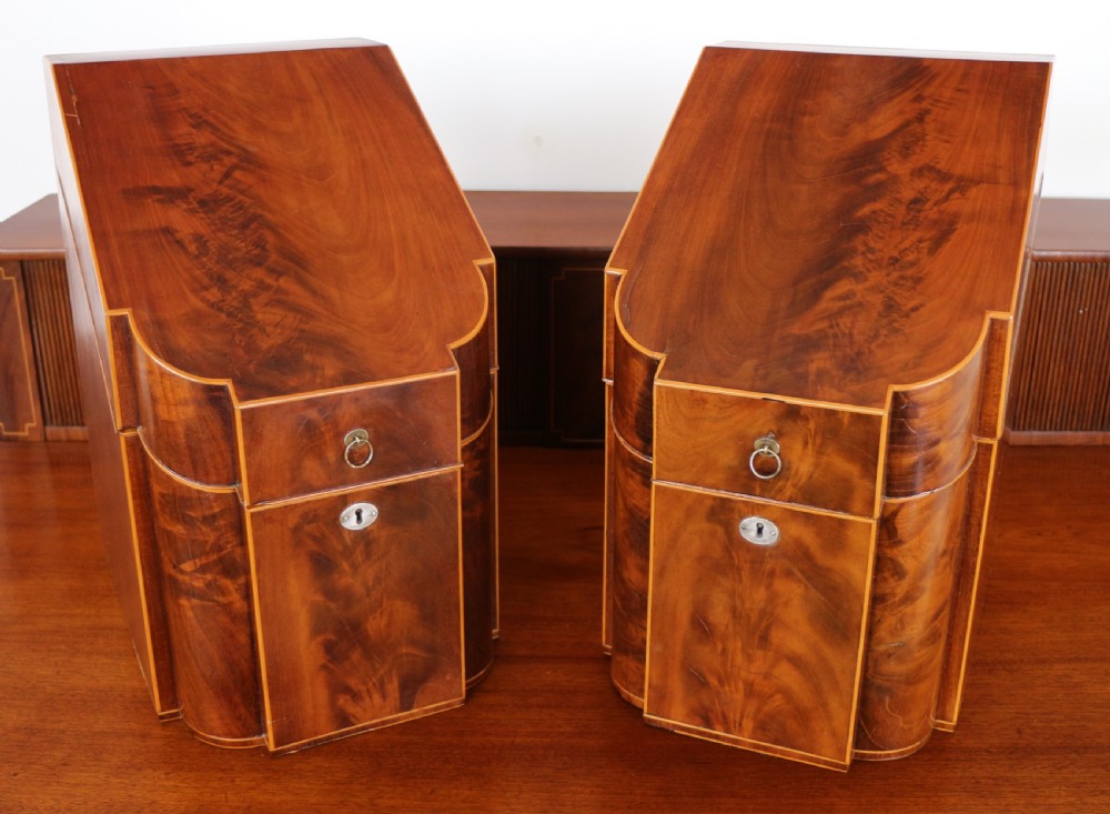 A George III Scottish flame mahogany stage-back sideboard featuring curved side drawers, inlay details, central tambour cupboards, and slender turned legs. View V