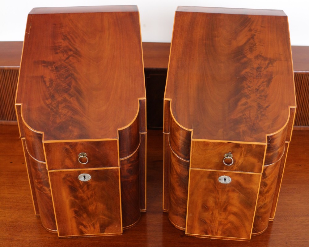 A George III Scottish flame mahogany stage-back sideboard featuring curved side drawers, inlay details, central tambour cupboards, and slender turned legs. View XXVI