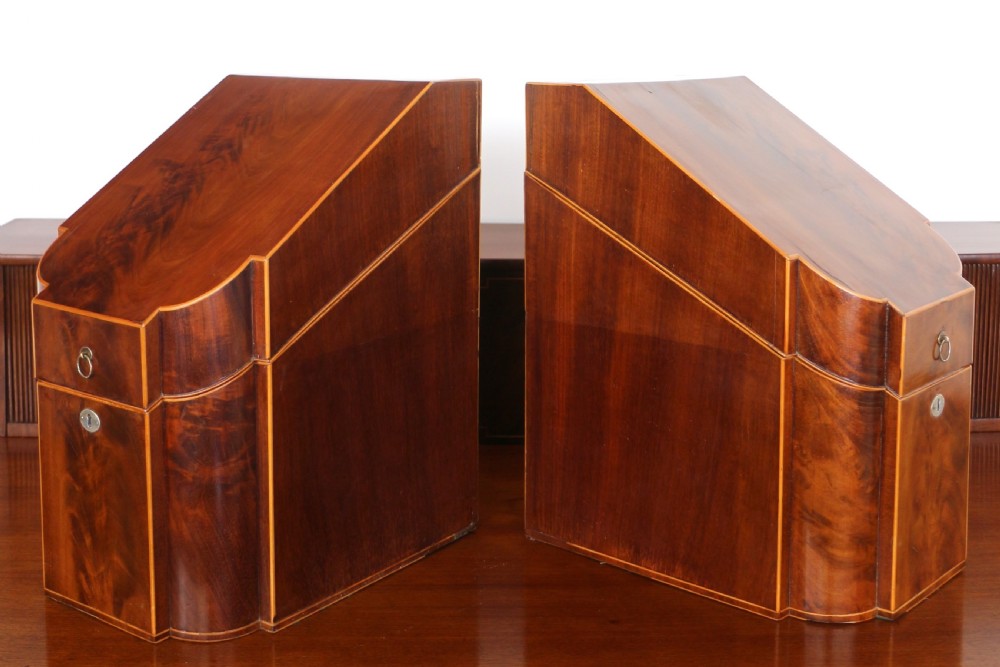 A George III Scottish flame mahogany stage-back sideboard featuring curved side drawers, inlay details, central tambour cupboards, and slender turned legs. View XXVII