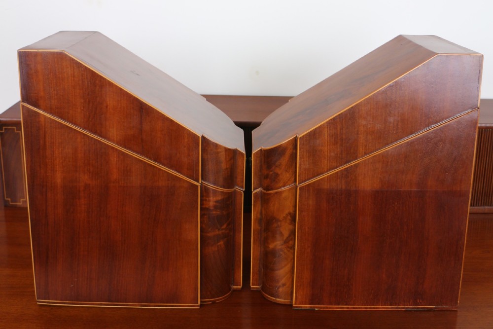 A George III Scottish flame mahogany stage-back sideboard featuring curved side drawers, inlay details, central tambour cupboards, and slender turned legs. View XXVIII