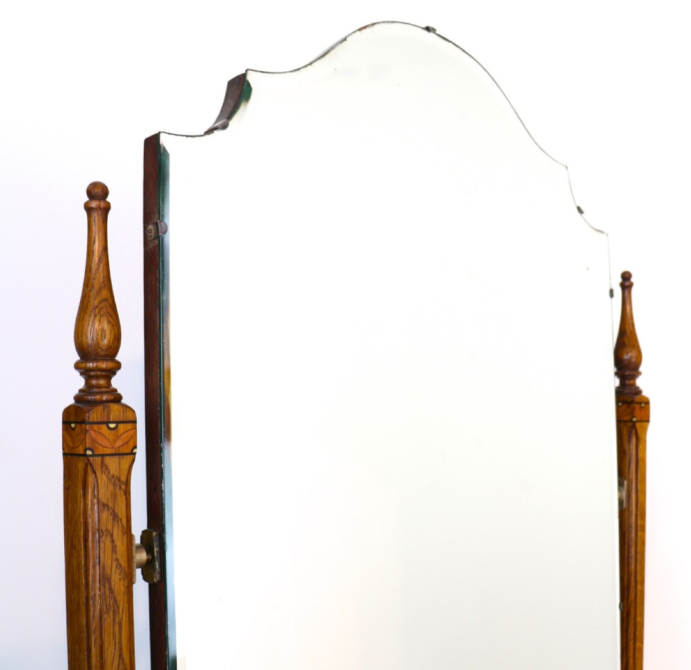 A three-piece golden oak Art Deco bedroom suite featuring a double wardrobe, dressing table with an arched mirror, and a small cupboard chest, all decorated with marquetry medallions. View XIII