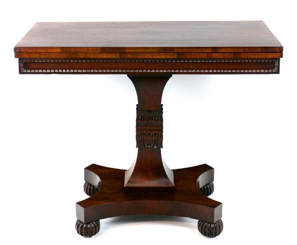 A Regency rosewood tea table featuring a rectangular fold-over top, bead moulding trim, a carved central pedestal, and a quadform base on carved feet. View XII