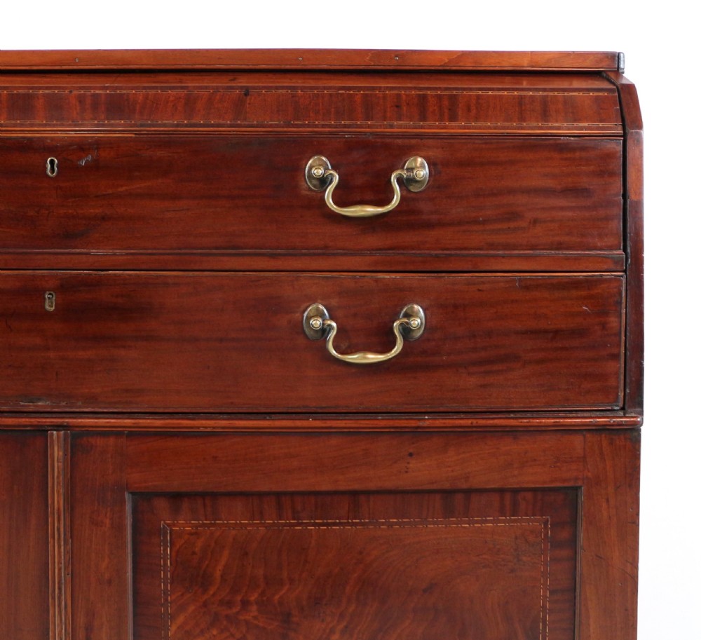 A George III mahogany secretaire low press cupboard featuring flame mahogany veneer panels, brass swan-neck handles, and bracket feet. View V