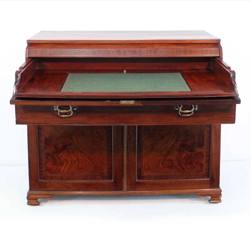 A George III mahogany secretaire low press cupboard featuring flame mahogany veneer panels, brass swan-neck handles, and bracket feet. View XVIII