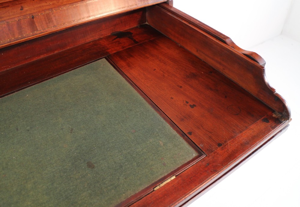 A George III mahogany secretaire low press cupboard featuring flame mahogany veneer panels, brass swan-neck handles, and bracket feet. View XIX