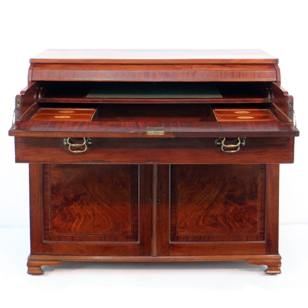 A George III mahogany secretaire low press cupboard featuring flame mahogany veneer panels, brass swan-neck handles, and bracket feet. View XXI