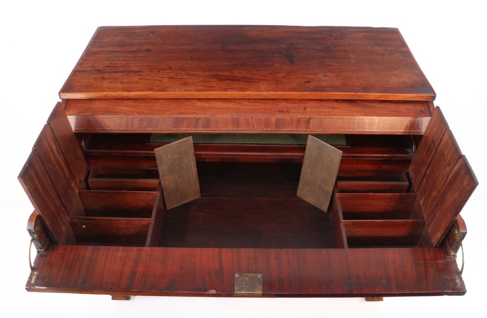 A George III mahogany secretaire low press cupboard featuring flame mahogany veneer panels, brass swan-neck handles, and bracket feet. View XXVI
