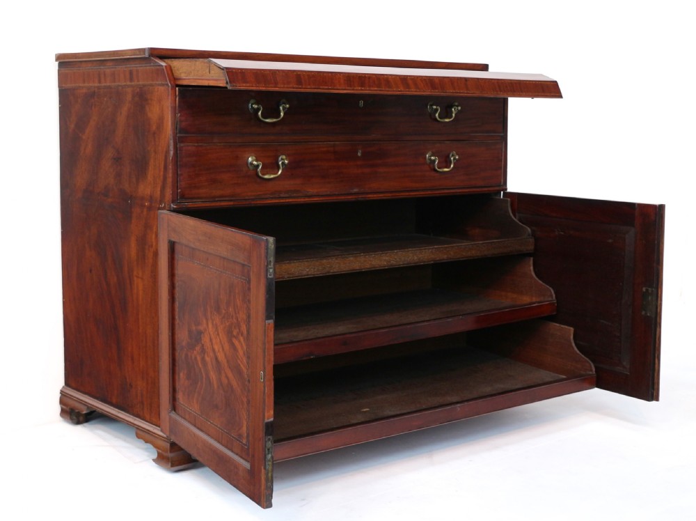 A George III mahogany secretaire low press cupboard featuring flame mahogany veneer panels, brass swan-neck handles, and bracket feet. View XXVII