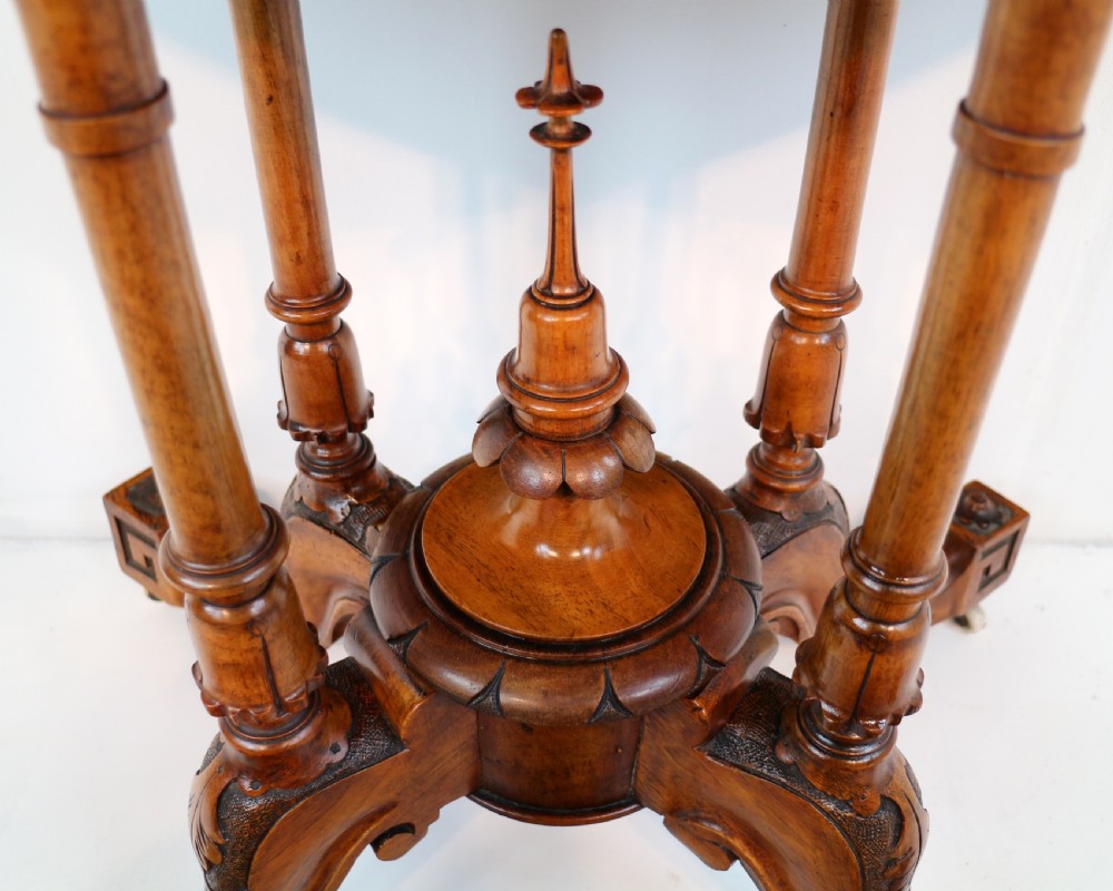 A Victorian burr walnut demilune card table featuring floral marquetry inlays, turned twin-column supports, and a carved central finial on quadruped legs. View III