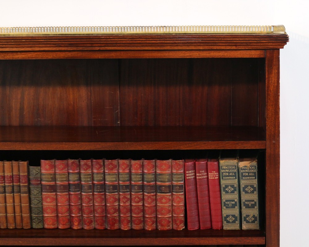 A Victorian walnut open bookcase featuring three horizontal shelves and a decorative brass gallery rail along the top edge. View XIII