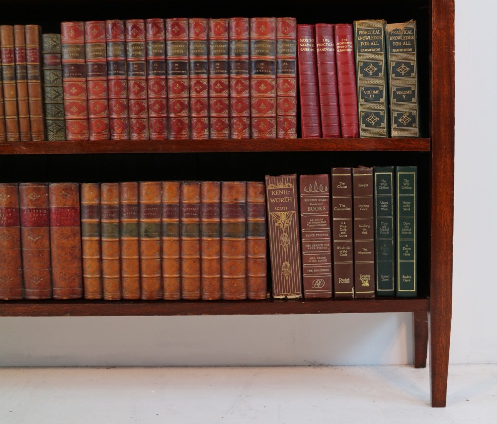 A Victorian walnut open bookcase featuring three horizontal shelves and a decorative brass gallery rail along the top edge. View XV