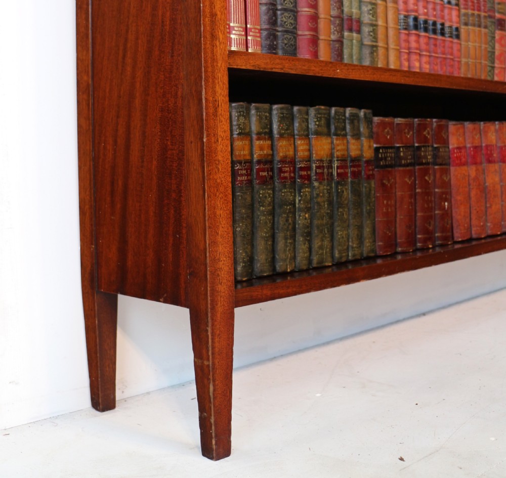 A Victorian walnut open bookcase featuring three horizontal shelves and a decorative brass gallery rail along the top edge. View XVIII