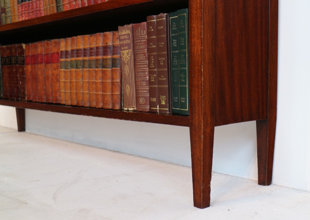 A Victorian walnut open bookcase featuring three horizontal shelves and a decorative brass gallery rail along the top edge. View XXI