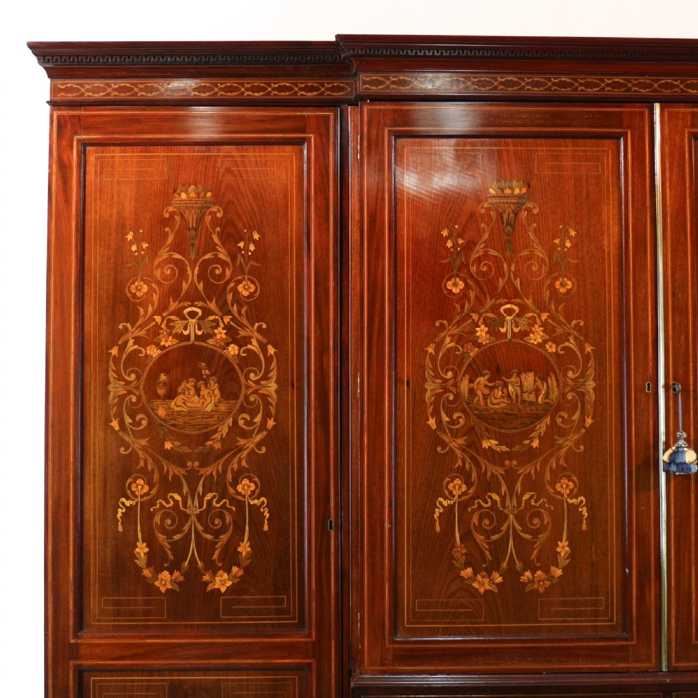 A large Victorian mahogany breakfront wardrobe with intricate floral marquetry inlays on the panel doors and lower drawer fronts. View II