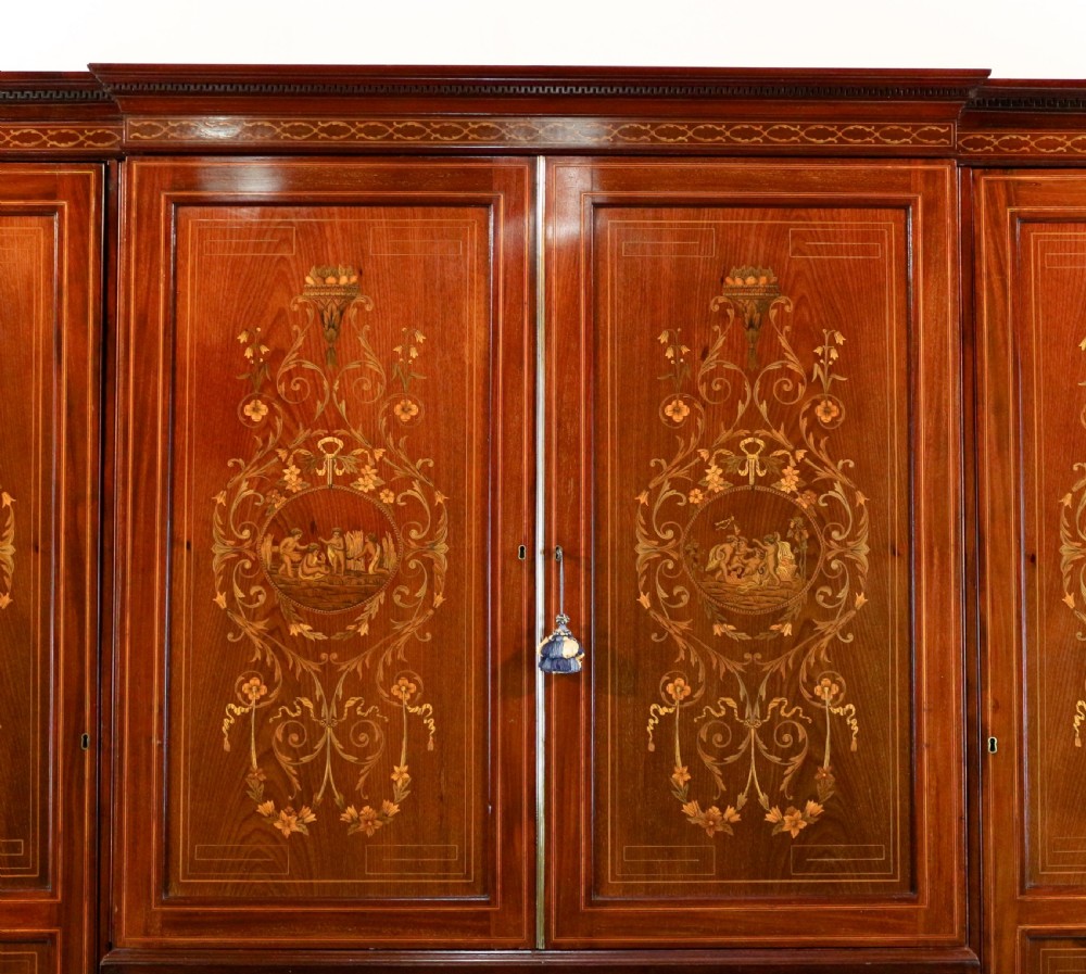 A large Victorian mahogany breakfront wardrobe with intricate floral marquetry inlays on the panel doors and lower drawer fronts. View III