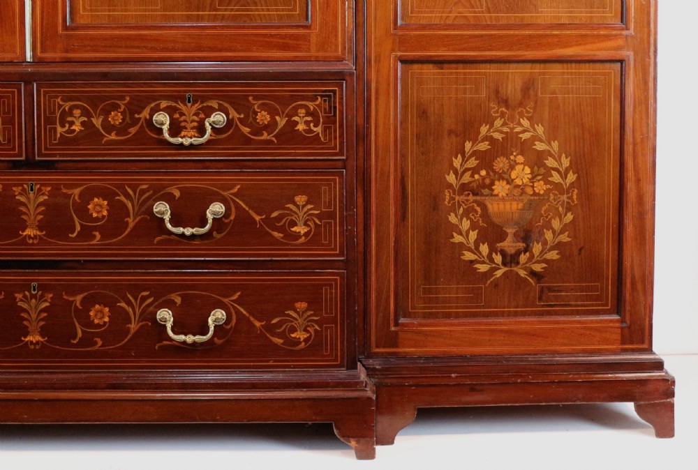 A large Victorian mahogany breakfront wardrobe with intricate floral marquetry inlays on the panel doors and lower drawer fronts. View VIII