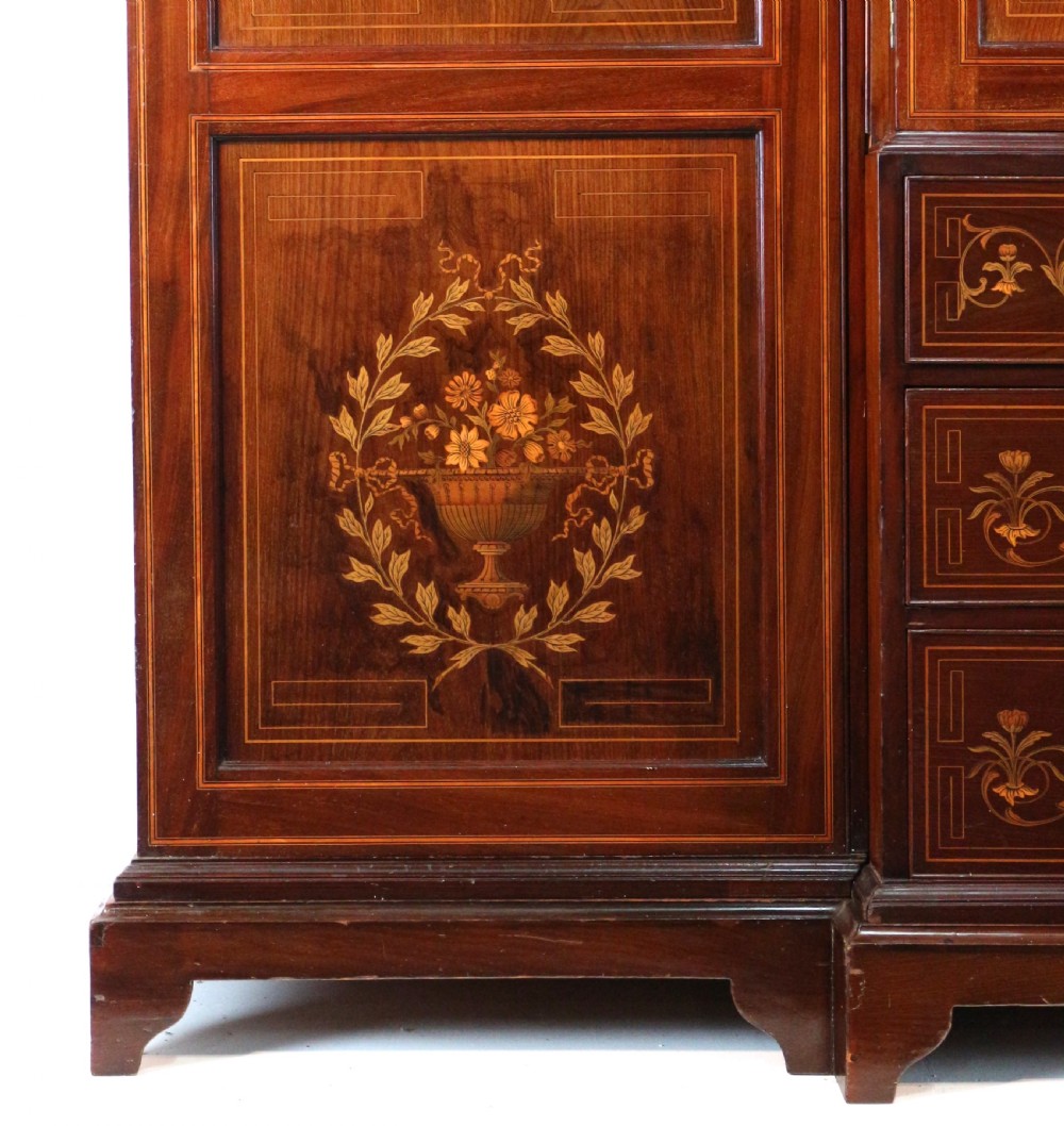 A large Victorian mahogany breakfront wardrobe with intricate floral marquetry inlays on the panel doors and lower drawer fronts. View IX