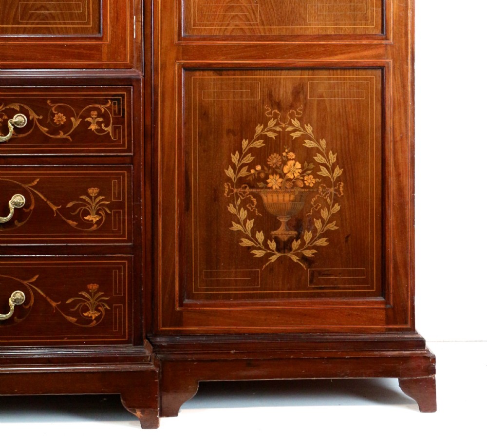 A large Victorian mahogany breakfront wardrobe with intricate floral marquetry inlays on the panel doors and lower drawer fronts. View X