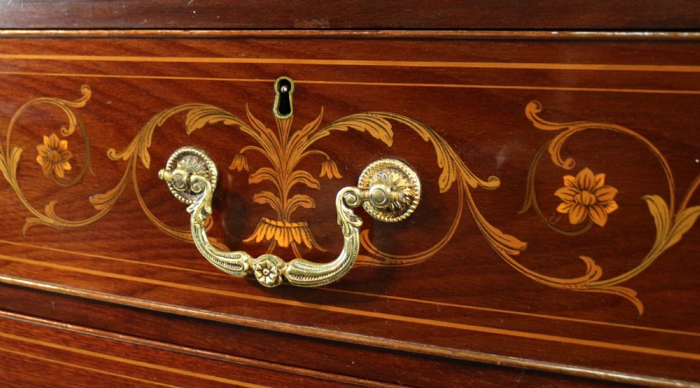 A large Victorian mahogany breakfront wardrobe with intricate floral marquetry inlays on the panel doors and lower drawer fronts. View XVII