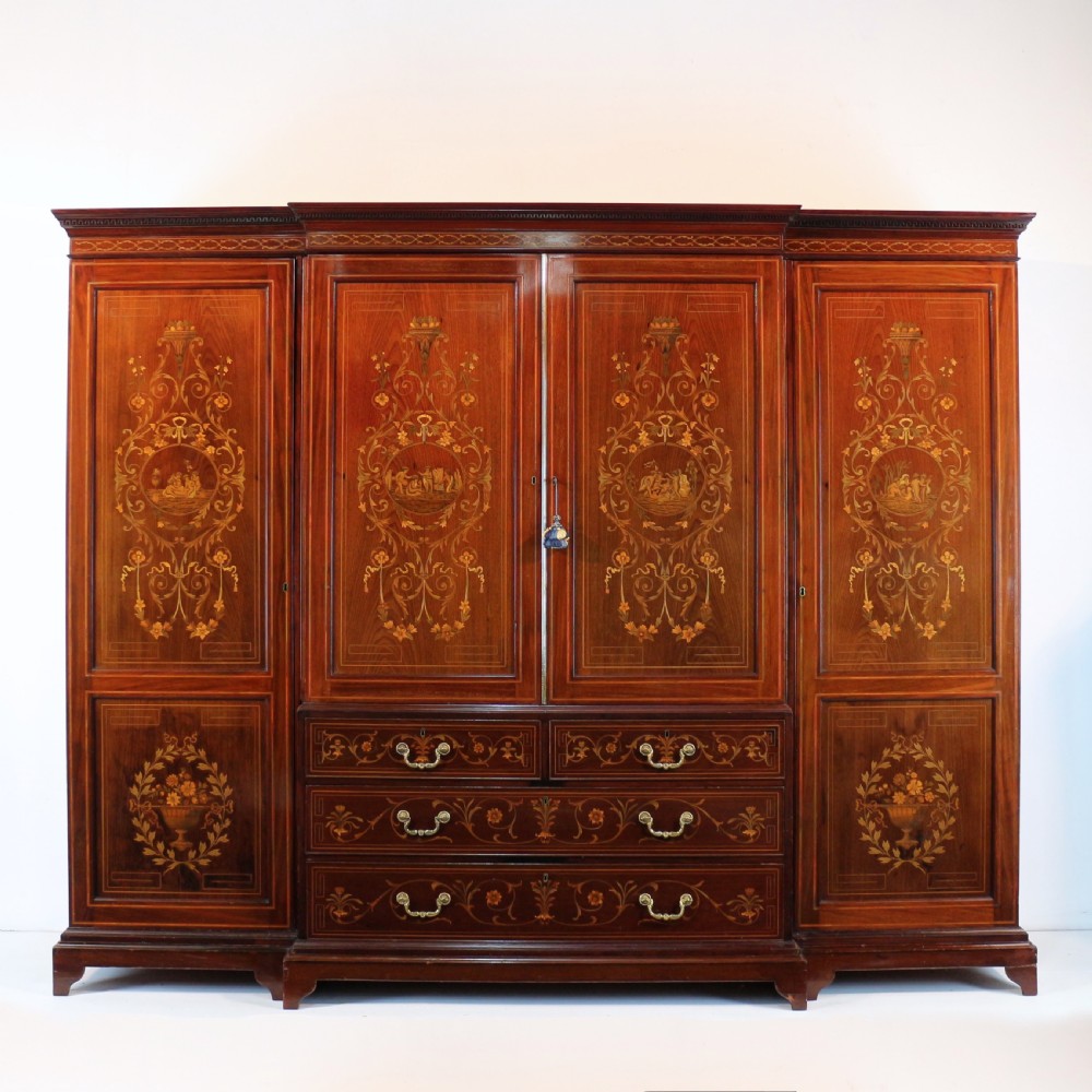 A large Victorian mahogany breakfront wardrobe with intricate floral marquetry inlays on the panel doors and lower drawer fronts. View XVIII