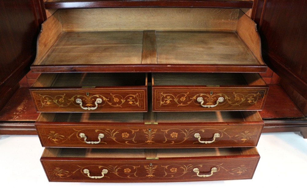 A large Victorian mahogany breakfront wardrobe with intricate floral marquetry inlays on the panel doors and lower drawer fronts. View XX