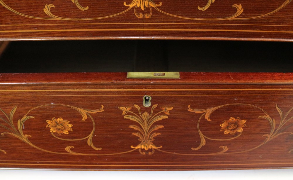 A large Victorian mahogany breakfront wardrobe with intricate floral marquetry inlays on the panel doors and lower drawer fronts. View XXI