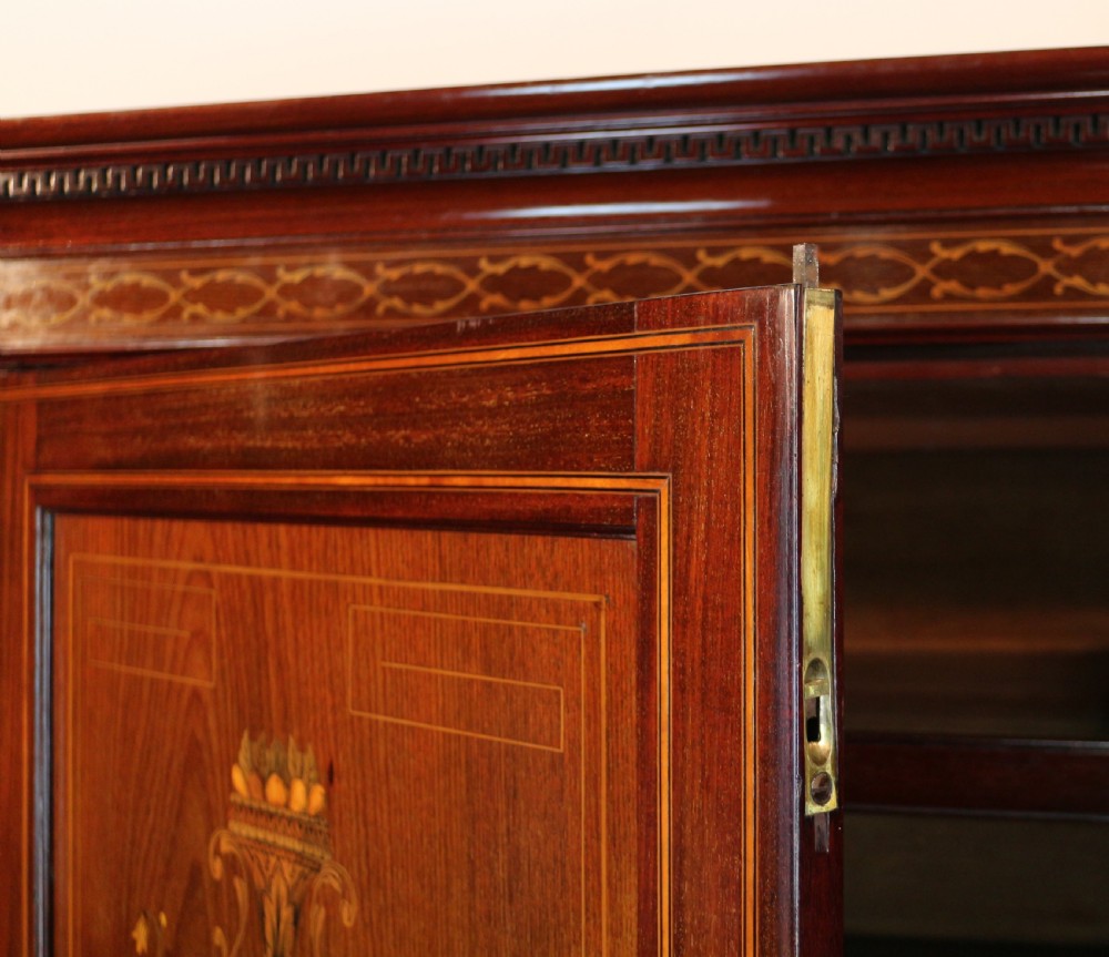 A large Victorian mahogany breakfront wardrobe with intricate floral marquetry inlays on the panel doors and lower drawer fronts. View XXII
