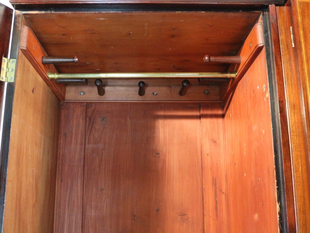 A large Victorian mahogany breakfront wardrobe with intricate floral marquetry inlays on the panel doors and lower drawer fronts. View XXIV