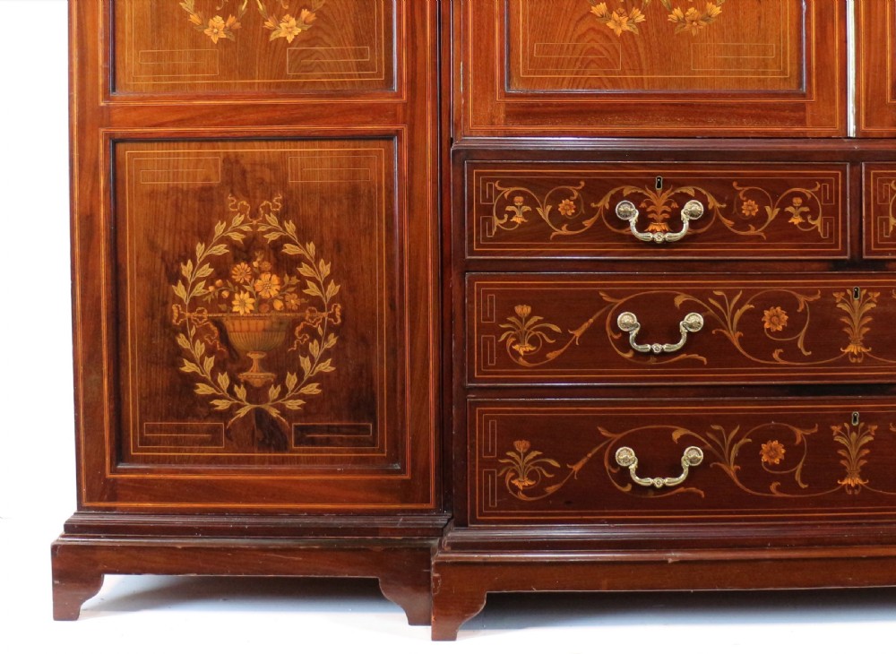 A large Victorian mahogany breakfront wardrobe with intricate floral marquetry inlays on the panel doors and lower drawer fronts. View XXXI