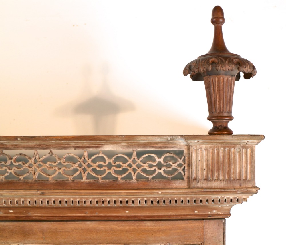 A large George III Chippendale period double bookcase crafted in natural pine, featuring astragal glazed upper doors topped with urn finials and lower panelled cupboards. View XV