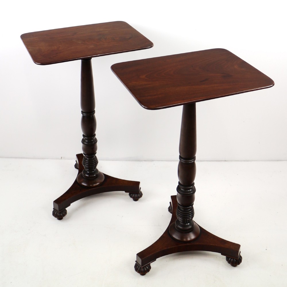 A pair of mahogany Regency wine tables featuring rounded rectangular tops, central turned pedestal columns, and tri-form bases resting on carved feet. View II