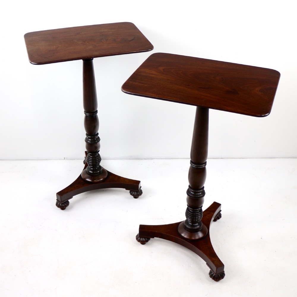 A pair of mahogany Regency wine tables featuring rounded rectangular tops, central turned pedestal columns, and tri-form bases resting on carved feet. View III