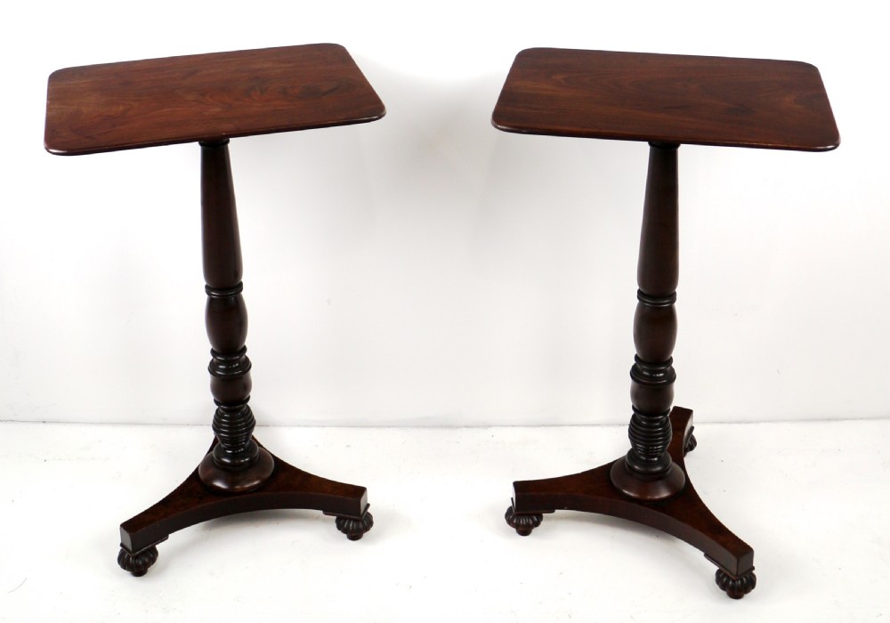 A pair of mahogany Regency wine tables featuring rounded rectangular tops, central turned pedestal columns, and tri-form bases resting on carved feet. View V