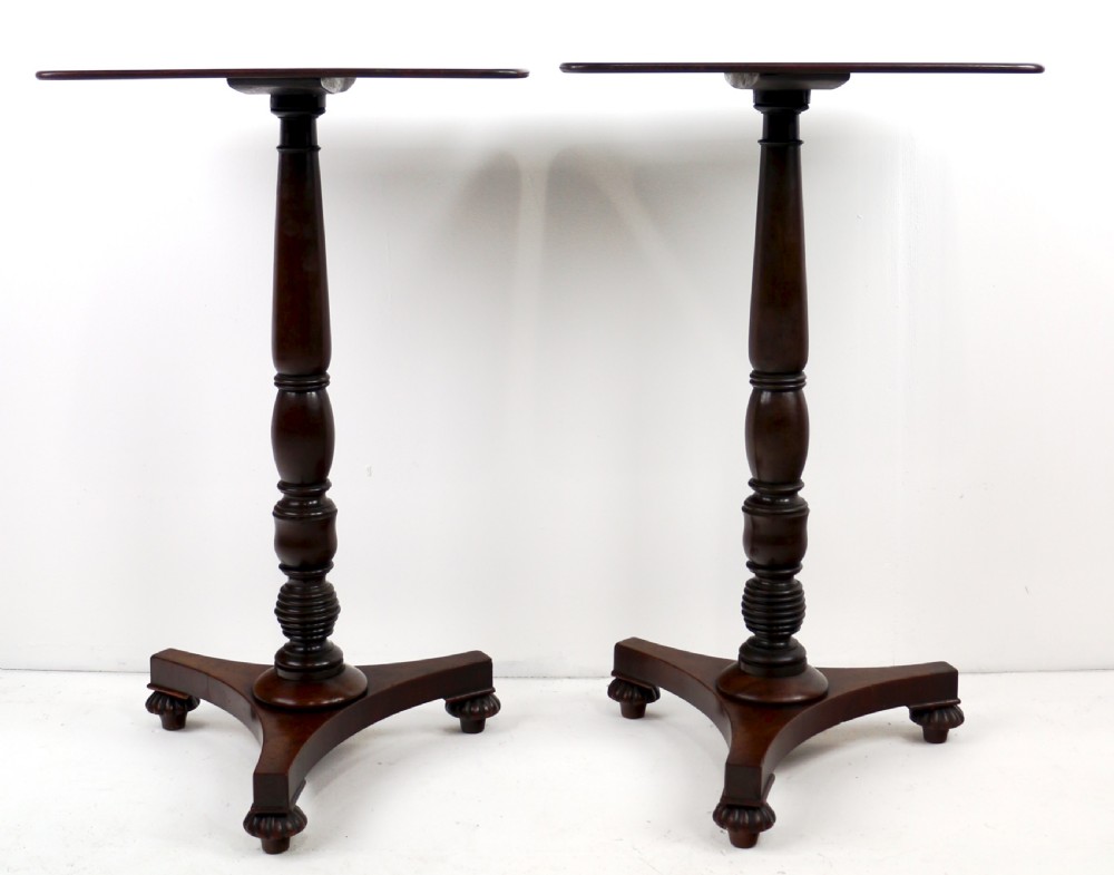 A pair of mahogany Regency wine tables featuring rounded rectangular tops, central turned pedestal columns, and tri-form bases resting on carved feet. View XII