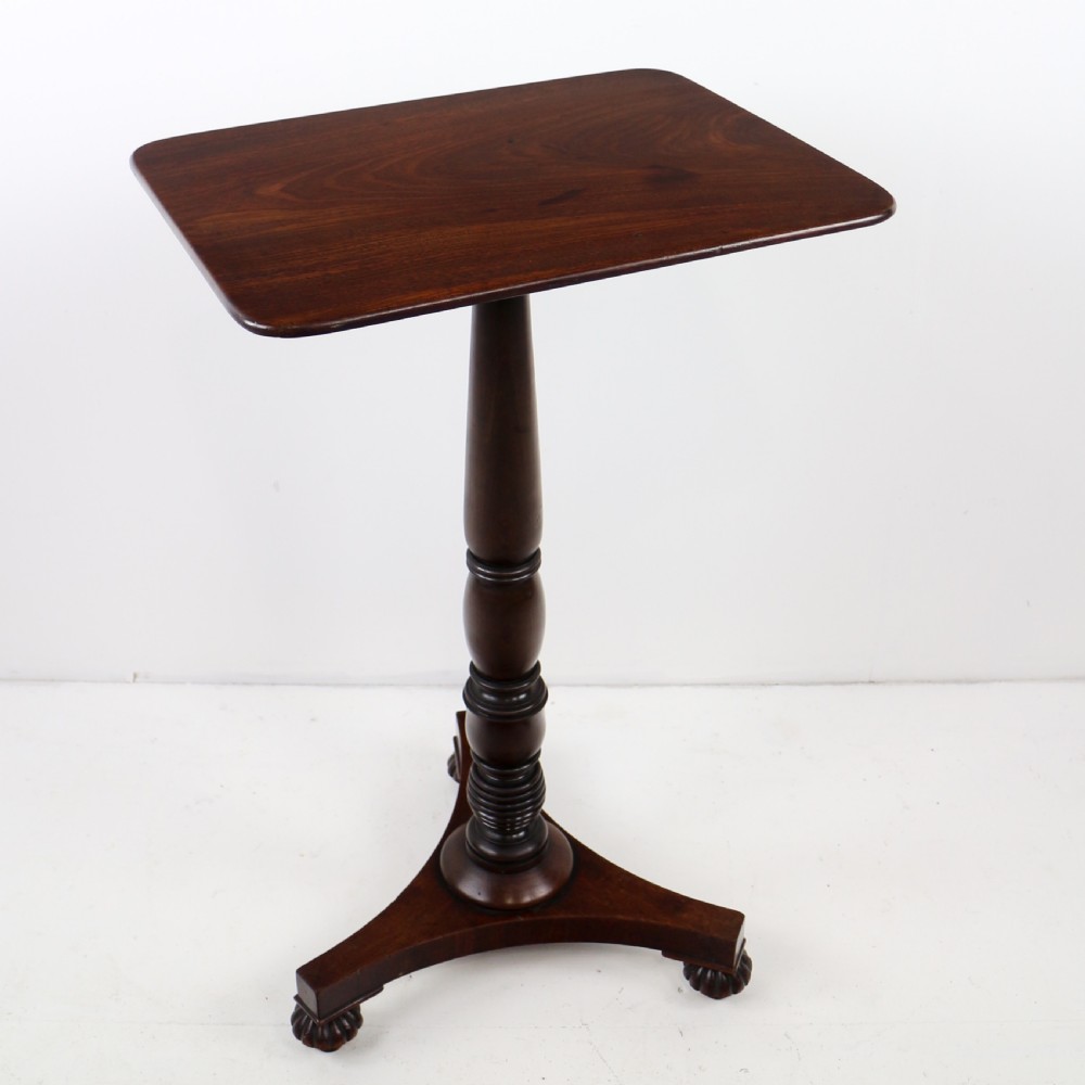 A pair of mahogany Regency wine tables featuring rounded rectangular tops, central turned pedestal columns, and tri-form bases resting on carved feet. View XIV