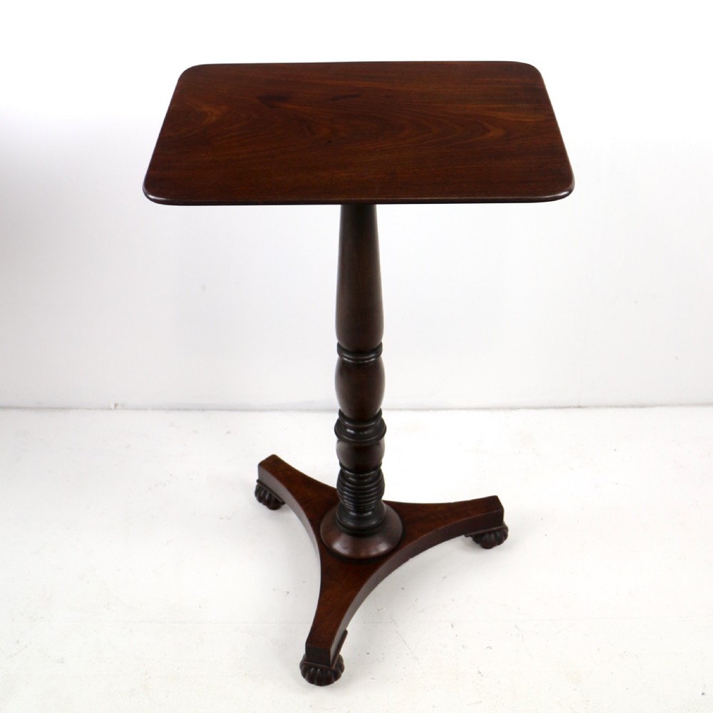 A pair of mahogany Regency wine tables featuring rounded rectangular tops, central turned pedestal columns, and tri-form bases resting on carved feet. View XV