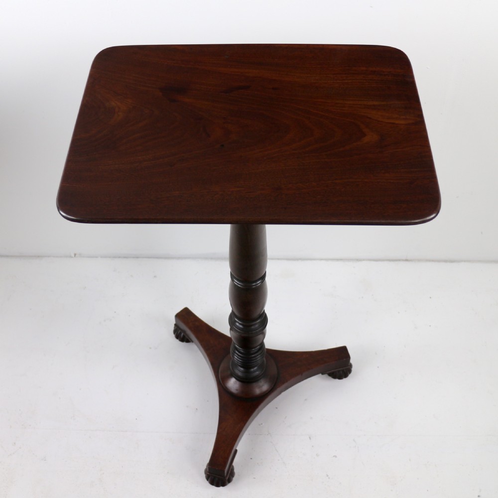 A pair of mahogany Regency wine tables featuring rounded rectangular tops, central turned pedestal columns, and tri-form bases resting on carved feet. View XVI