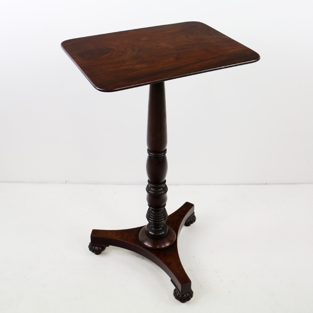 A pair of mahogany Regency wine tables featuring rounded rectangular tops, central turned pedestal columns, and tri-form bases resting on carved feet. View XVIII