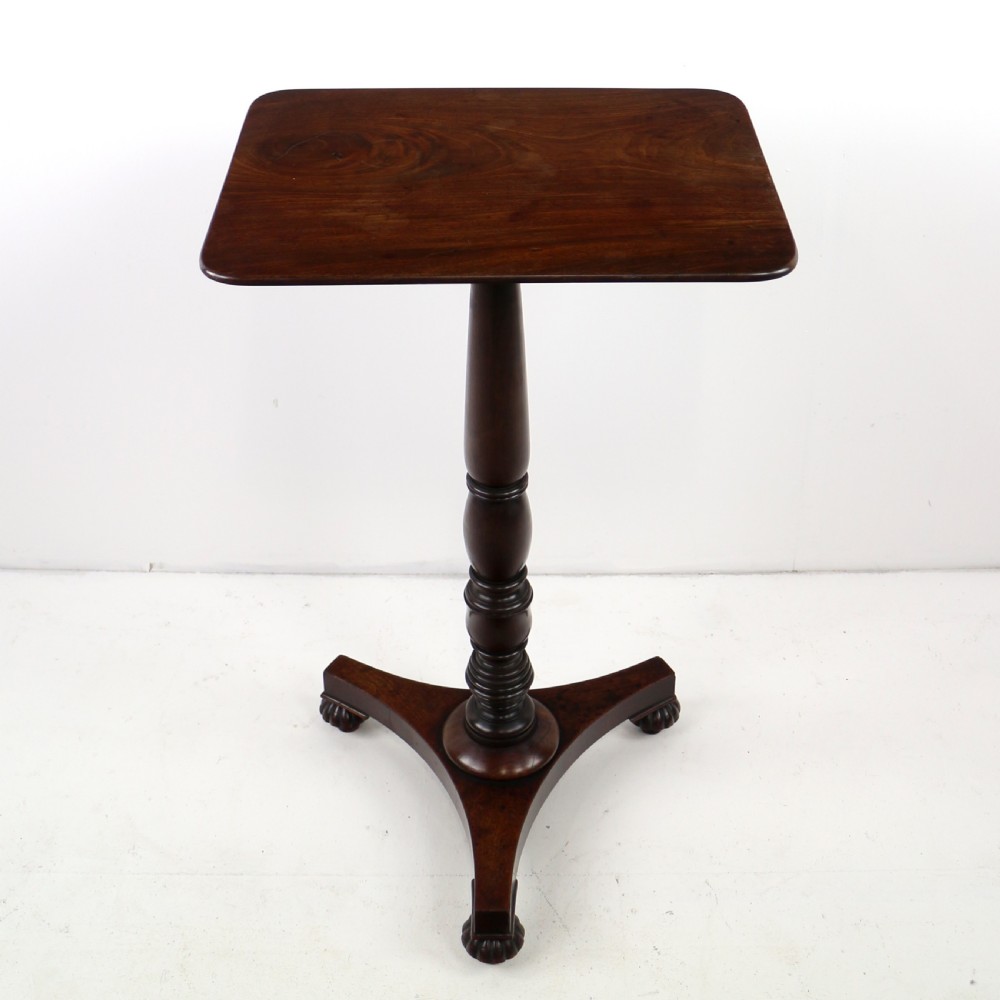 A pair of mahogany Regency wine tables featuring rounded rectangular tops, central turned pedestal columns, and tri-form bases resting on carved feet. View XIX