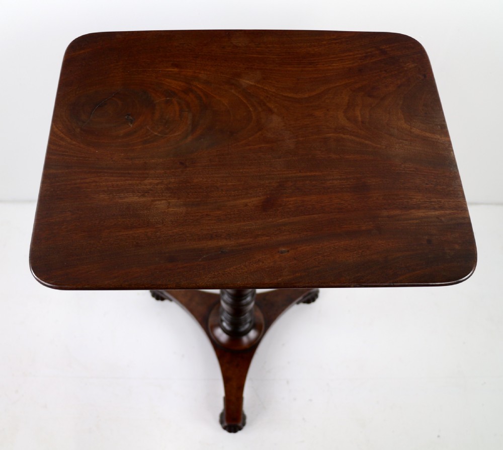 A pair of mahogany Regency wine tables featuring rounded rectangular tops, central turned pedestal columns, and tri-form bases resting on carved feet. View XXI
