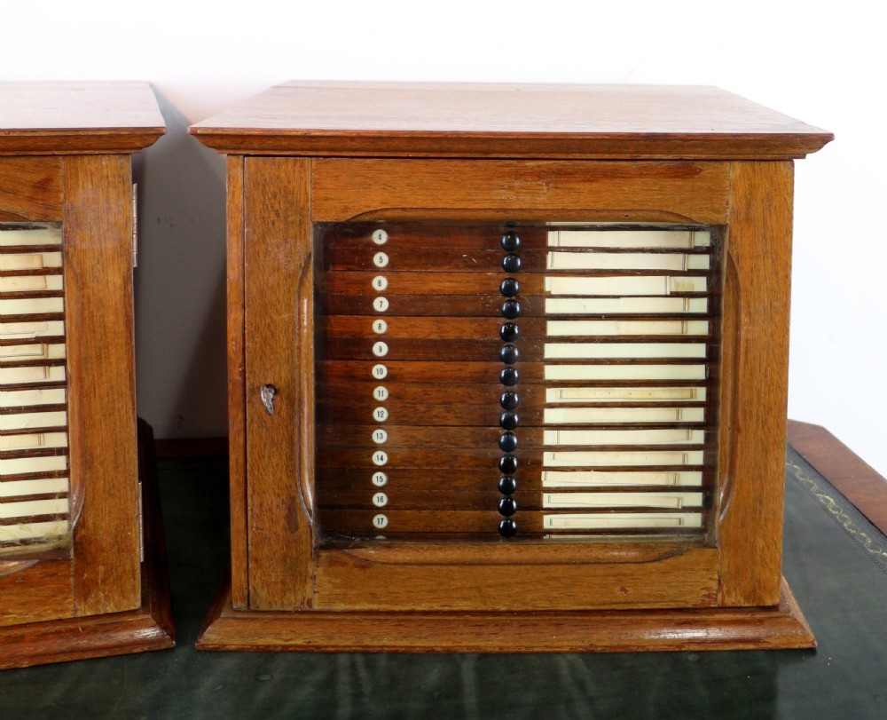 A pair of late nineteenth-century walnut microscope slide cabinets featuring glazed doors revealing shallow numbered drawers. View VI