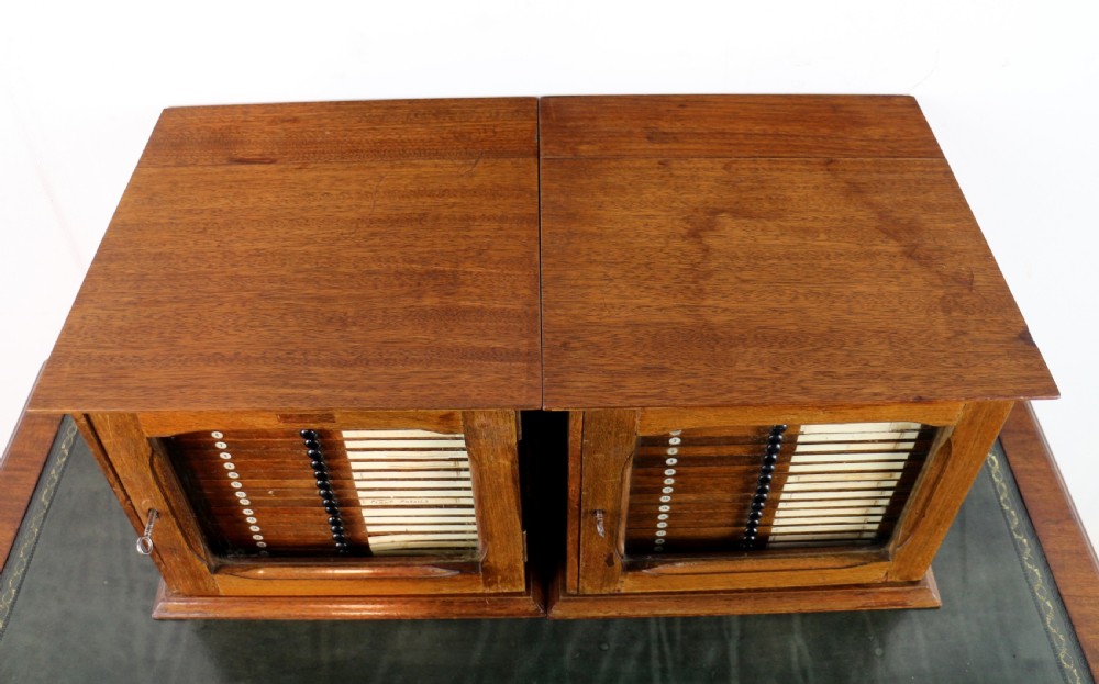 A pair of late nineteenth-century walnut microscope slide cabinets featuring glazed doors revealing shallow numbered drawers. View VIII