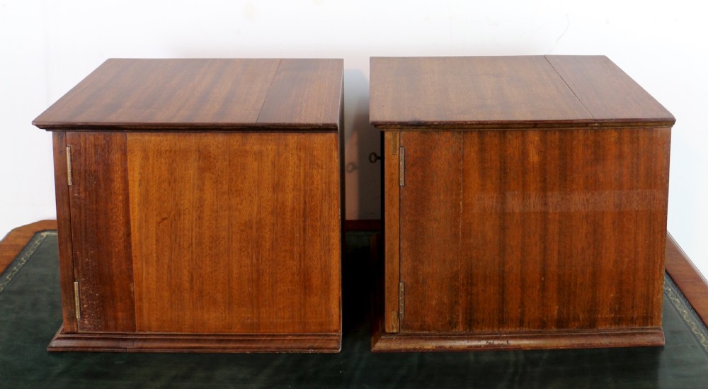 A pair of late nineteenth-century walnut microscope slide cabinets featuring glazed doors revealing shallow numbered drawers. View XXX