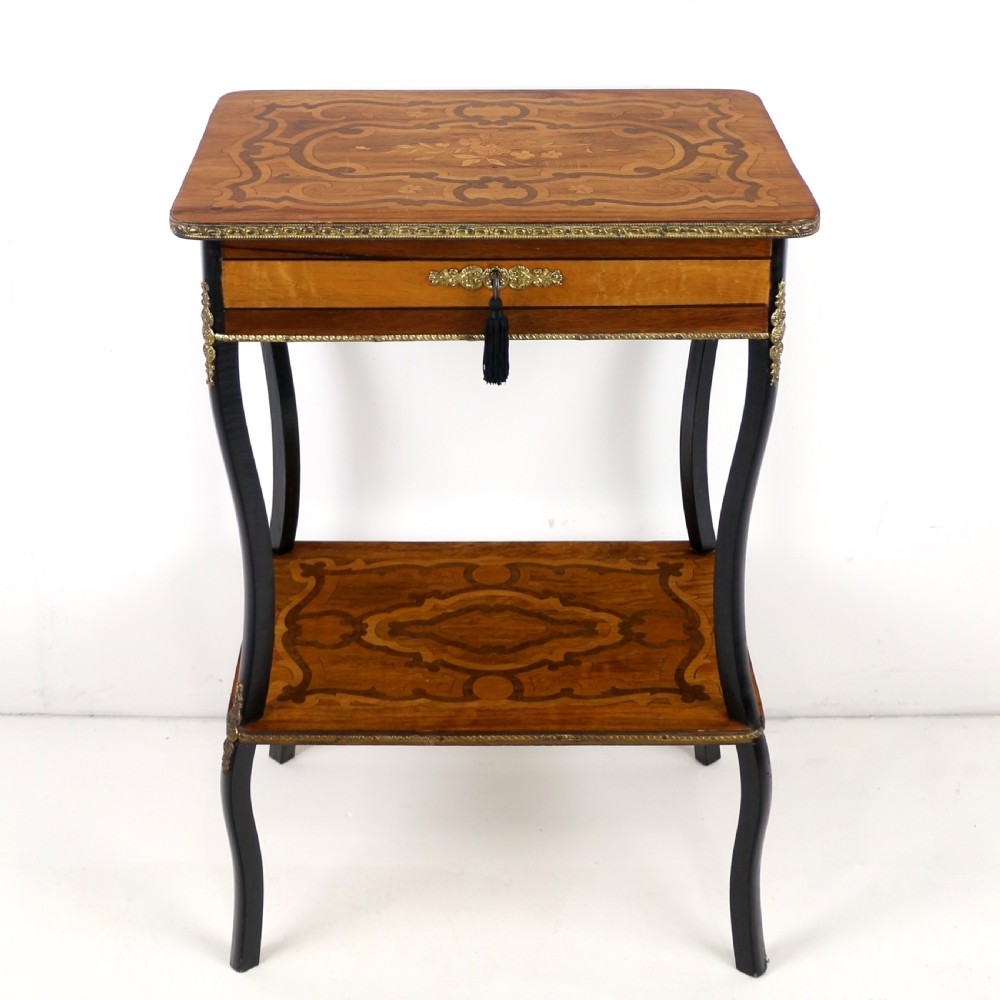 A late 19th-century French Napoleon III work table featuring floral marquetry inlays, ebonised legs, a single lockable drawer, and a lower shelf with brass mouldings. View II