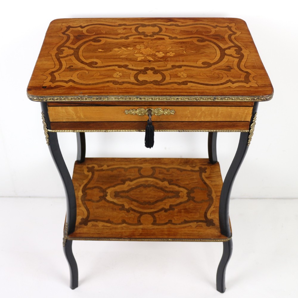 A late 19th-century French Napoleon III work table featuring floral marquetry inlays, ebonised legs, a single lockable drawer, and a lower shelf with brass mouldings. View III